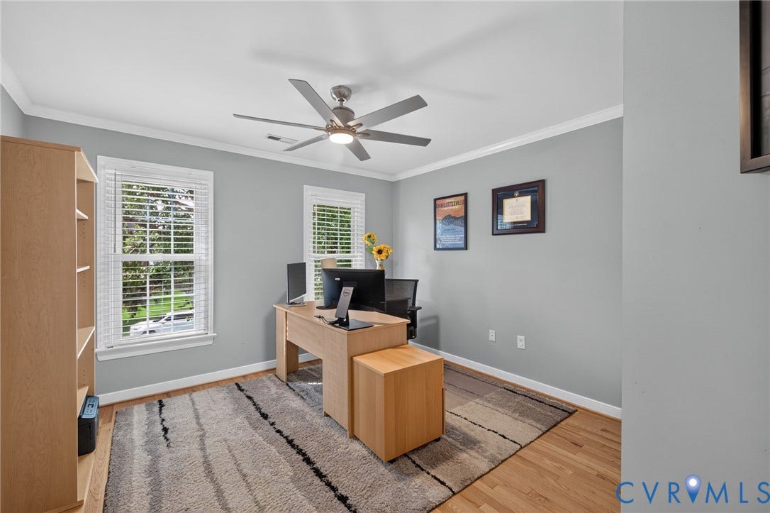 12320 Bradford Landing Way, Glen Allen, VA 23059 Bright interior room featuring hardwood flooring, crown molding, double windows with blinds, a ceiling fan, and light gray walls