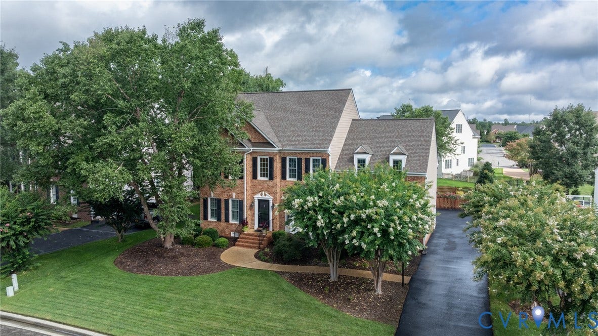 12320 Bradford Landing Way, Glen Allen, VA 23059 Two-story brick facade residence with a stone accent foundation and dark shuttered windows