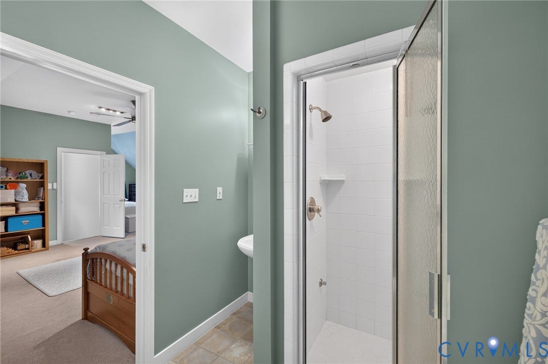 12320 Bradford Landing Way, Glen Allen, VA 23059 Three-quarter bathroom featuring a glass-enclosed shower with white subway tile surround, brushed nickel fixtures, and a wall-mounted sink