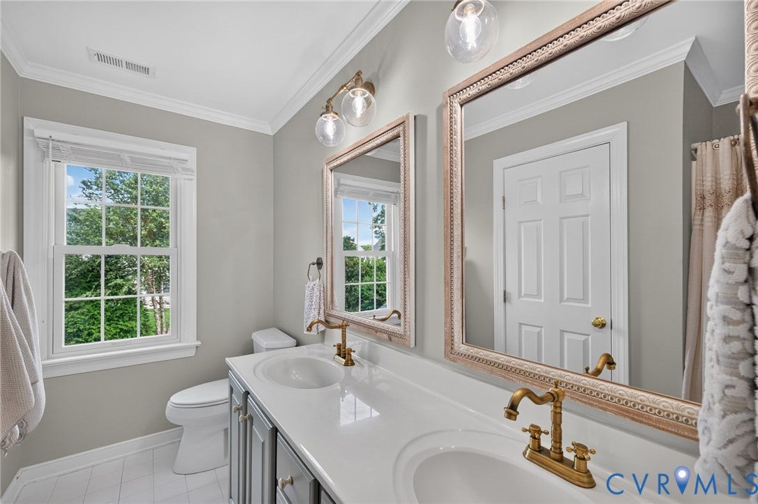 12320 Bradford Landing Way, Glen Allen, VA 23059 Bathroom featuring a dual vanity with white countertops, undermount sinks, and brass fixtures