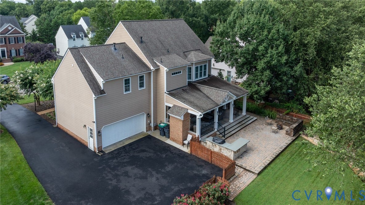 12320 Bradford Landing Way, Glen Allen, VA 23059 Expansive outdoor living area featuring a covered patio with columns, a large paver stone patio, and a built-in outdoor kitchen island