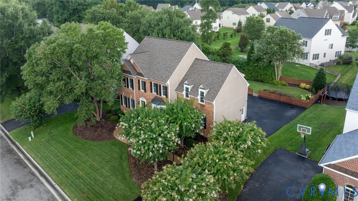 12320 Bradford Landing Way, Glen Allen, VA 23059 Brick and siding exterior featuring a multi-gable roofline, dormer windows, and black louvered shutters