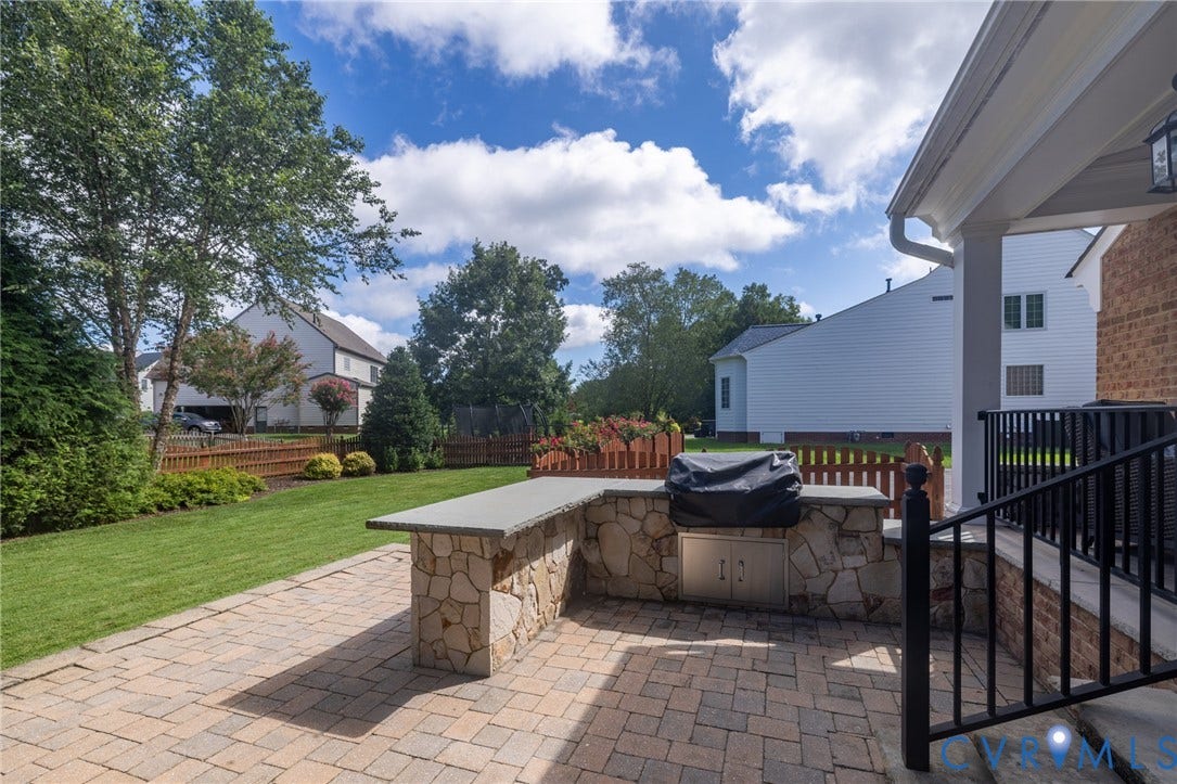 12320 Bradford Landing Way, Glen Allen, VA 23059 Paved patio featuring a built-in outdoor kitchen with stone veneer and a stone countertop