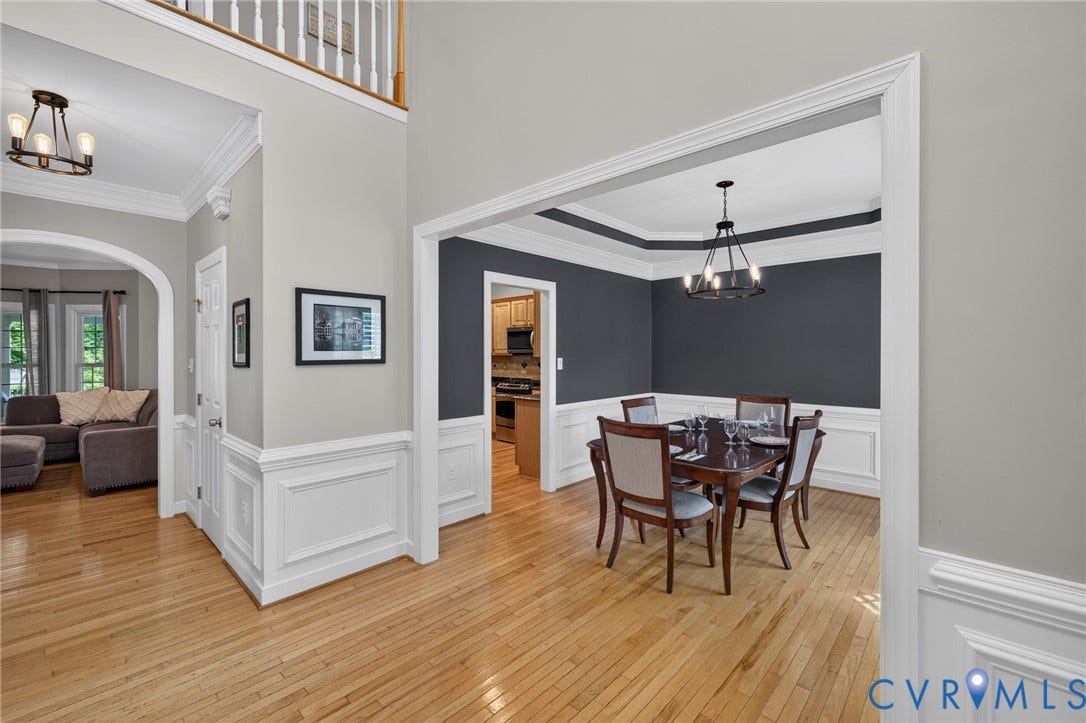 12320 Bradford Landing Way, Glen Allen, VA 23059 Formal dining space featuring a tray ceiling, wainscoting, hardwood flooring, and a modern chandelier