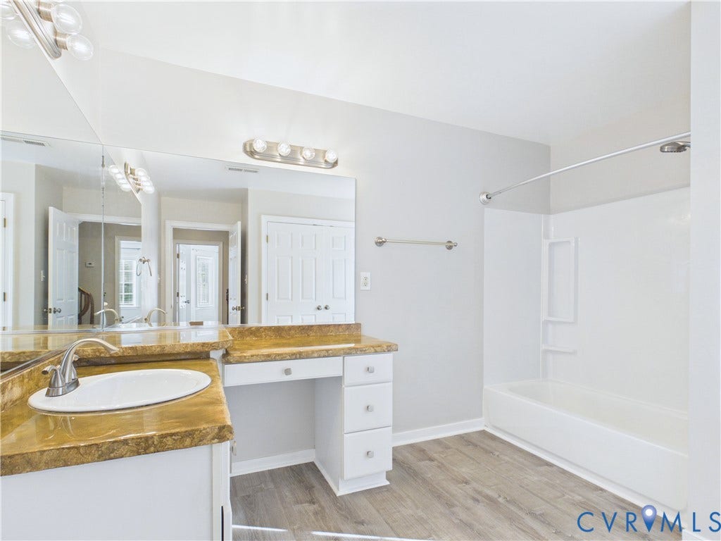 4515 Exton Lane, Chester, VA 23831 Bathroom featuring a white vanity with an undermount sink, a warm-toned countertop, and a built-in makeup vanity