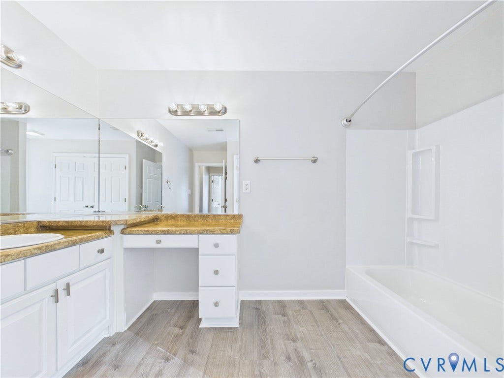 4515 Exton Lane, Chester, VA 23831 Bathroom featuring a vanity with a drop-in sink, stone-finish countertop, white cabinetry, and wood-finish flooring