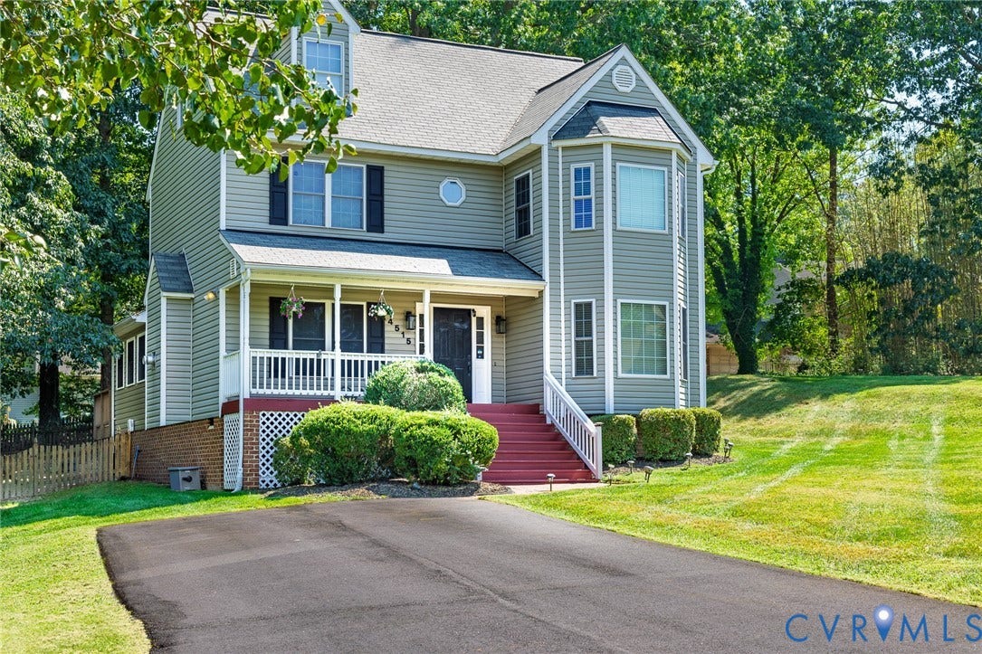 4515 Exton Lane, Chester, VA 23831 Two-story residence featuring light gray siding, a covered front porch, and a bay window
