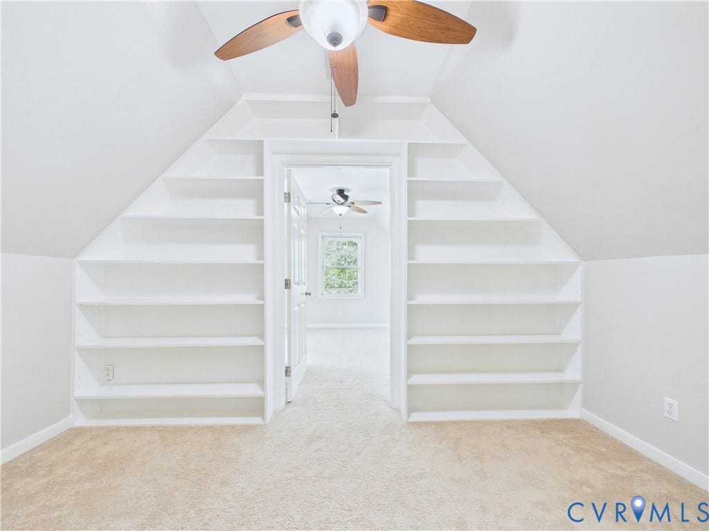 4515 Exton Lane, Chester, VA 23831 Angled ceiling with a ceiling fan, symmetrical built-in shelving, and carpet flooring