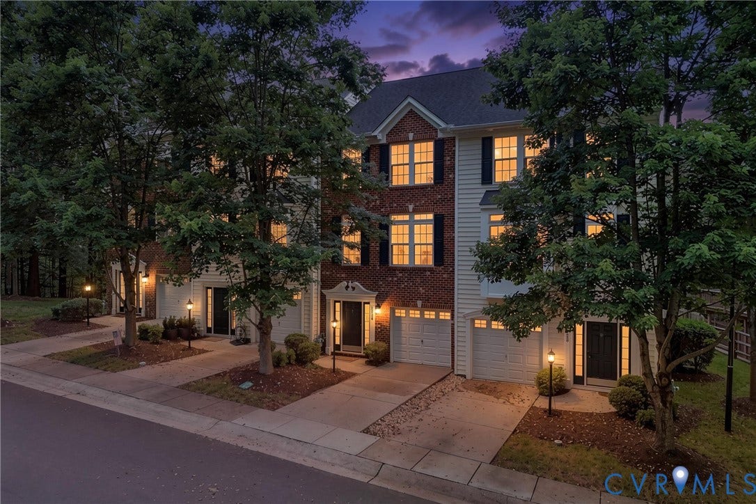 Townhome exterior featuring brick and siding accents