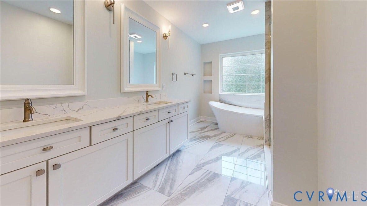 Double vanity with white cabinetry and quartz countertops