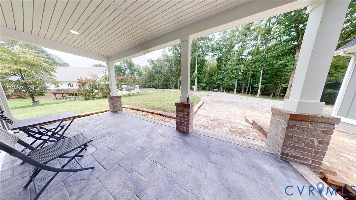 Covered patio featuring stamped concrete flooring