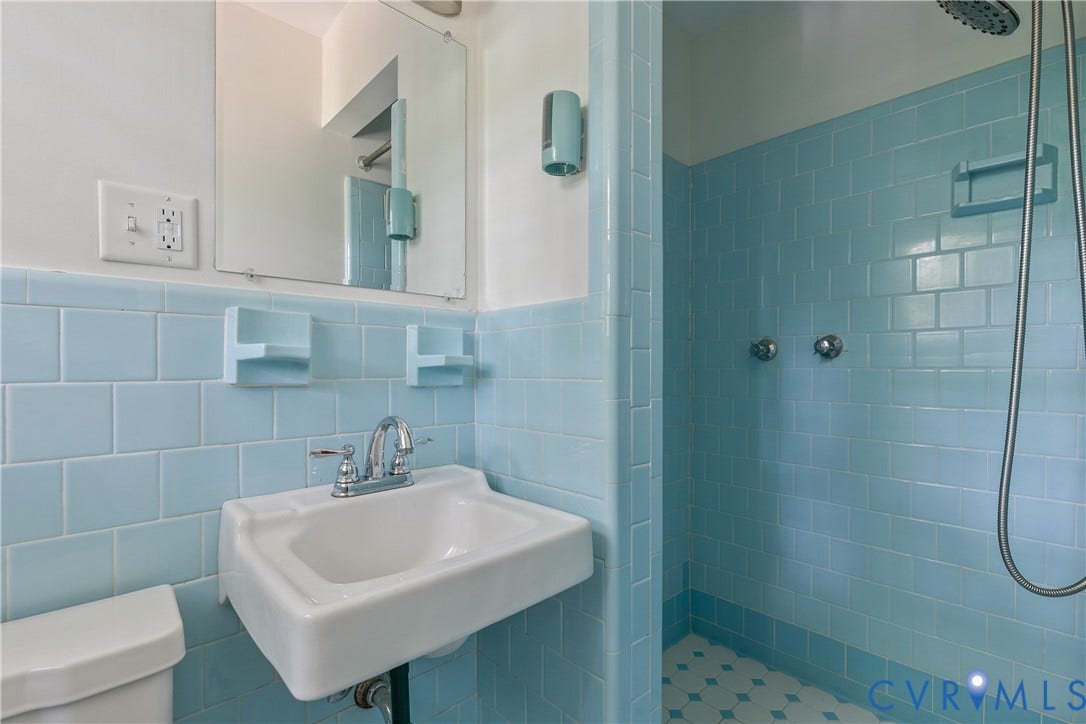200 Stanmore Road, North Chesterfield, VA 23236 Light blue ceramic wall tiling with a wall-mounted sink and chrome-finish faucet