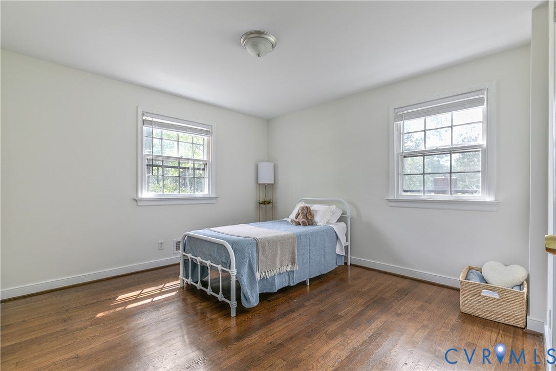 200 Stanmore Road, North Chesterfield, VA 23236 Hardwood flooring, two windows with blinds, white trim, and a ceiling-mounted light fixture