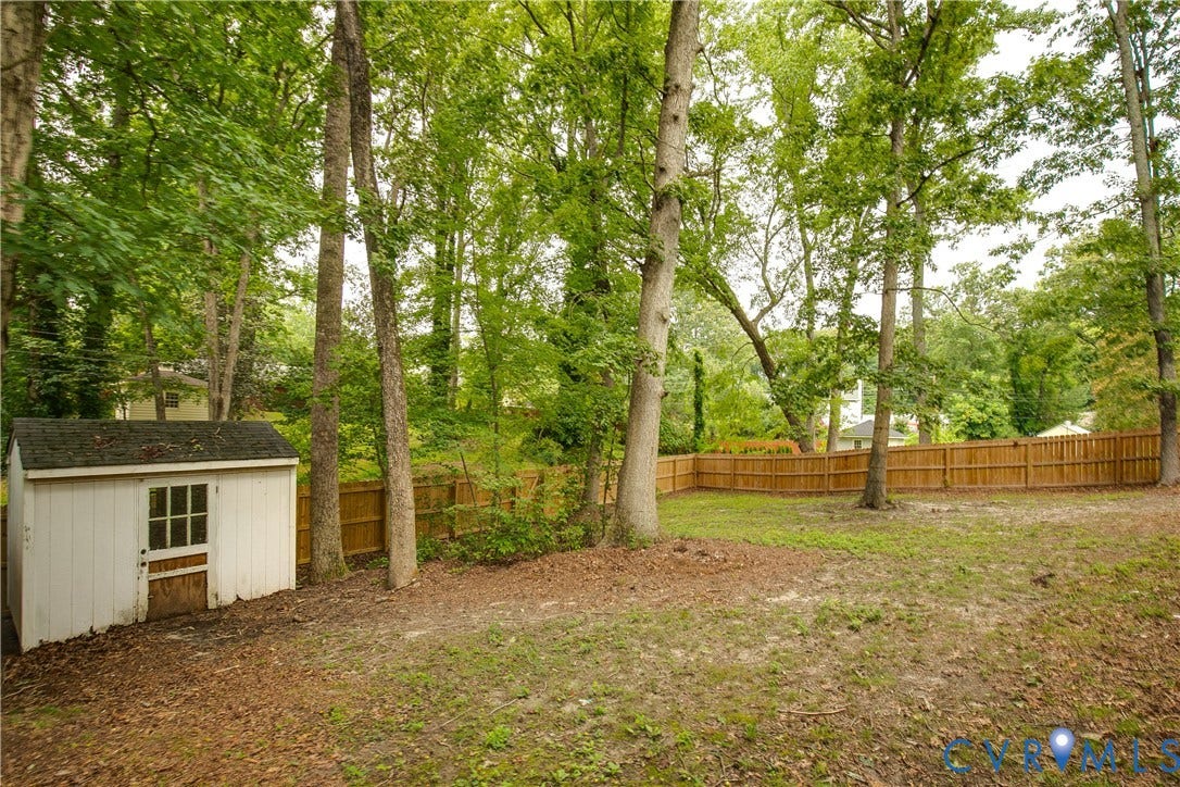 200 Stanmore Road, North Chesterfield, VA 23236 Fenced backyard with mature trees and a white storage shed