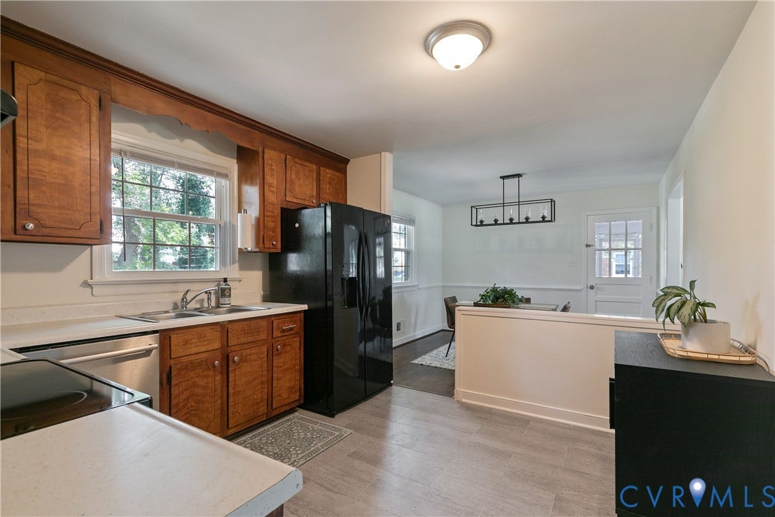 200 Stanmore Road, North Chesterfield, VA 23236 Kitchen with wood cabinetry, stainless steel dishwasher, black refrigerator, and wood-finish flooring