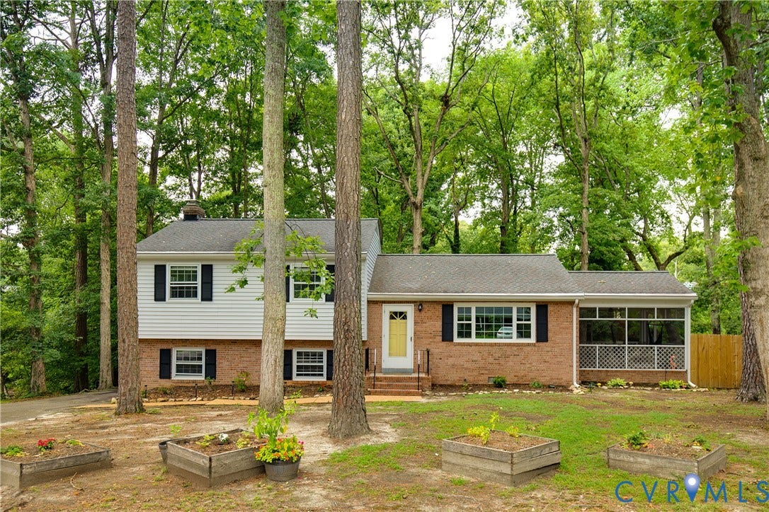 200 Stanmore Road, North Chesterfield, VA 23236 Brick and siding exterior with a screened porch, prominent mature trees, and a gravel driveway