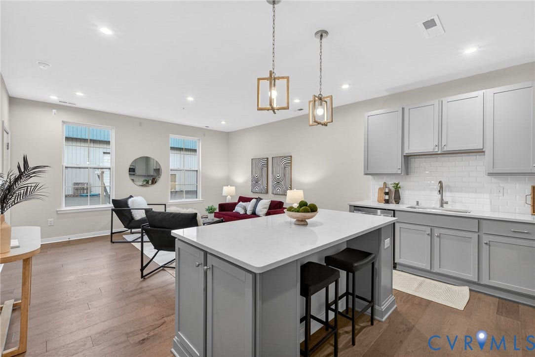 2439 Ownby Lane, #B 13, Richmond, VA 23220 Open-concept living space featuring wood-finish flooring, recessed lighting, and a kitchen island with seating