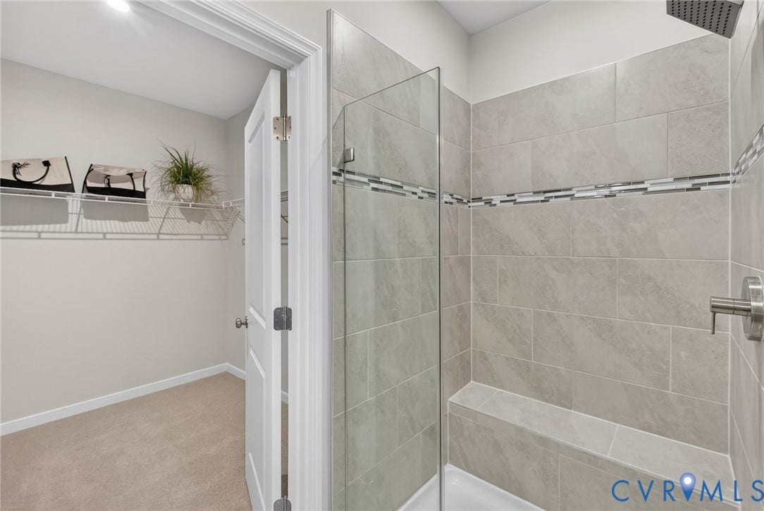 2439 Ownby Lane, #B 13, Richmond, VA 23220 Walk-in shower with full-height tile surround, integrated tiled bench, and glass enclosure