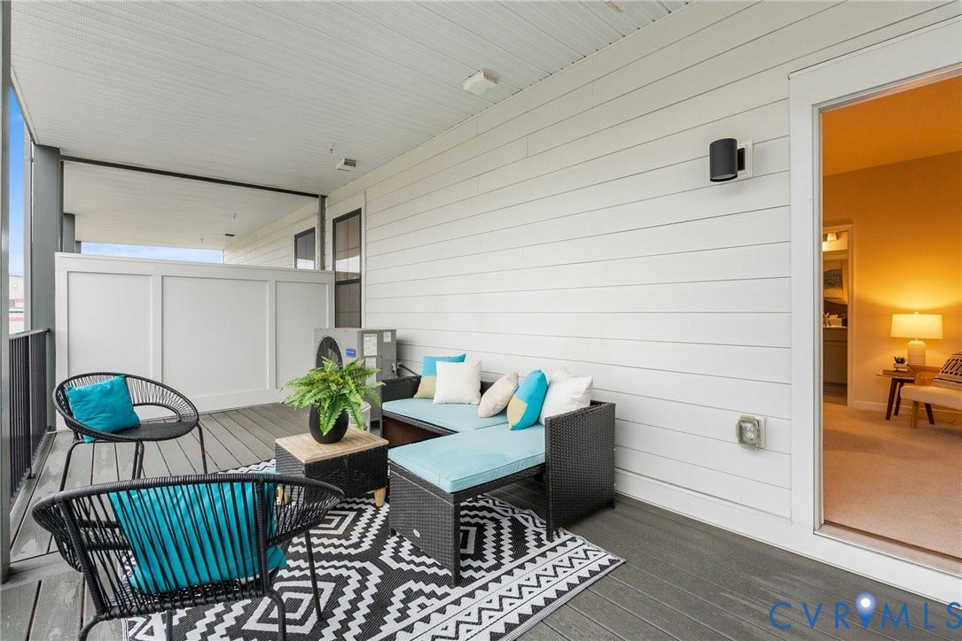 2439 Ownby Lane, #B 13, Richmond, VA 23220 Screened porch featuring wood-finish decking, white horizontal siding, and a white paneled privacy wall