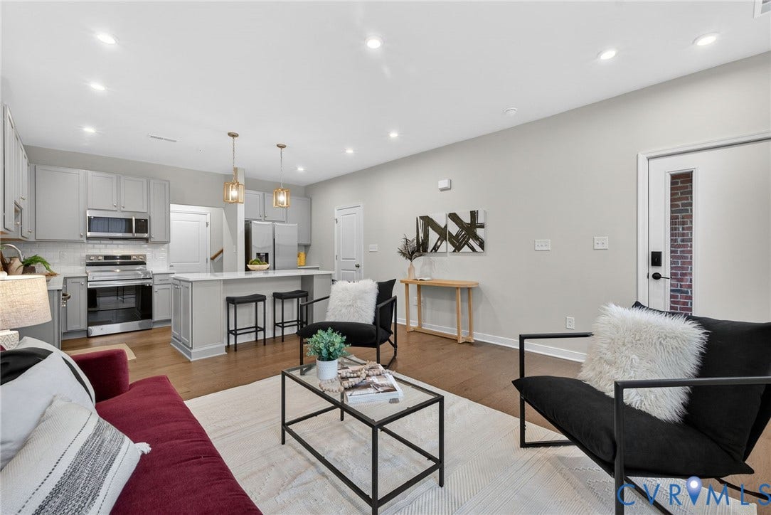 2439 Ownby Lane, #B 13, Richmond, VA 23220 Open-concept living space with wood-finish flooring, recessed lighting, and a kitchen featuring light gray cabinetry and stainless steel appliances
