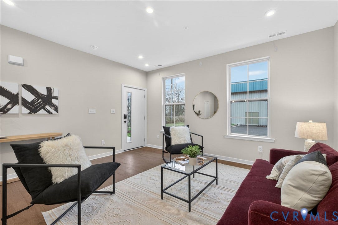 2439 Ownby Lane, #B 13, Richmond, VA 23220 Bright, light-filled living space showcasing recessed ceiling lighting, wood-finish flooring, and large multi-pane windows with natural light
