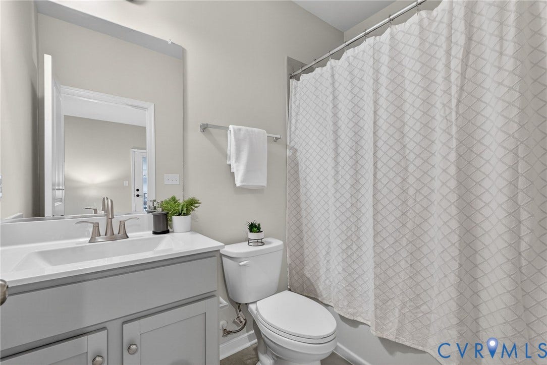 2439 Ownby Lane, #B 13, Richmond, VA 23220 White vanity with undermount sink, brushed nickel faucet, and integrated countertop