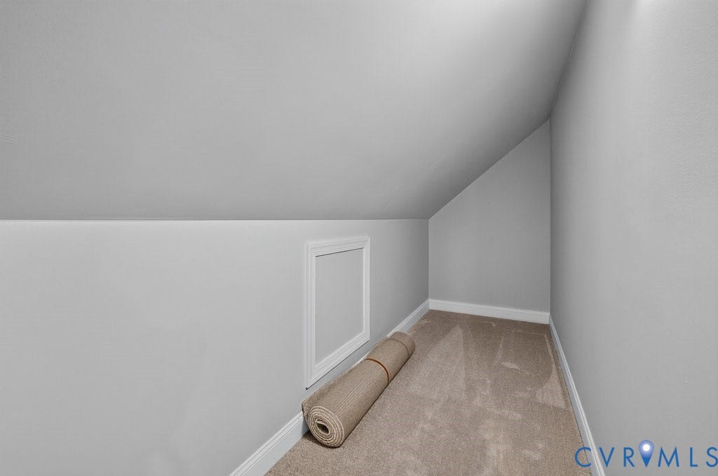 8825 First Branch Lane, Chesterfield, VA 23838 Sloped ceiling with light gray painted walls, a white trim access panel, and neutral-toned carpet flooring
