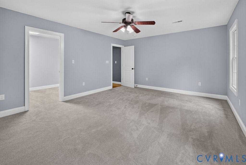 8825 First Branch Lane, Chesterfield, VA 23838 Spacious room with light gray carpeting, neutral wall color, white trim, a ceiling fan, and a large window