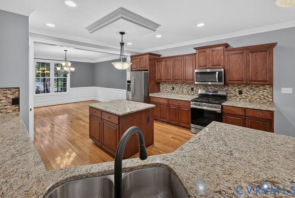 8825 First Branch Lane, Chesterfield, VA 23838 Kitchen featuring wood cabinetry, stainless steel appliances, granite countertops, and a decorative tile backsplash