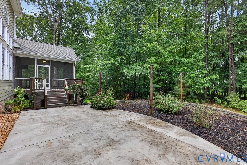 8825 First Branch Lane, Chesterfield, VA 23838 Concrete patio with a screened porch, exterior steps, and a landscaped retaining wall