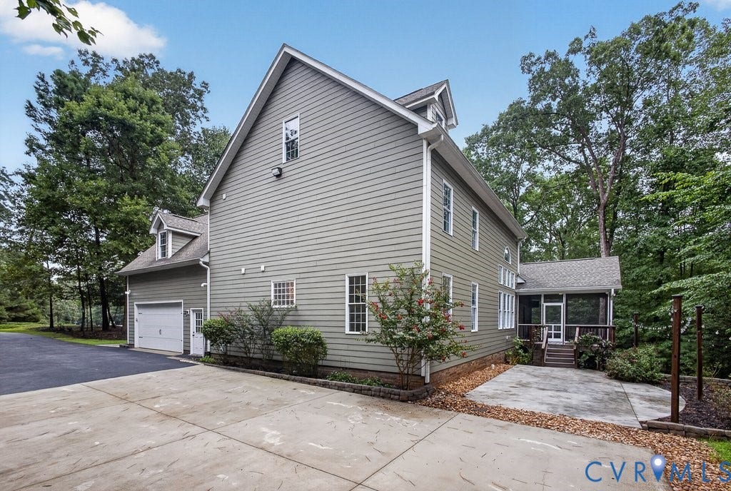 8825 First Branch Lane, Chesterfield, VA 23838 Siding exterior with multiple windows, two-car garage, dormer windows, and a screened porch
