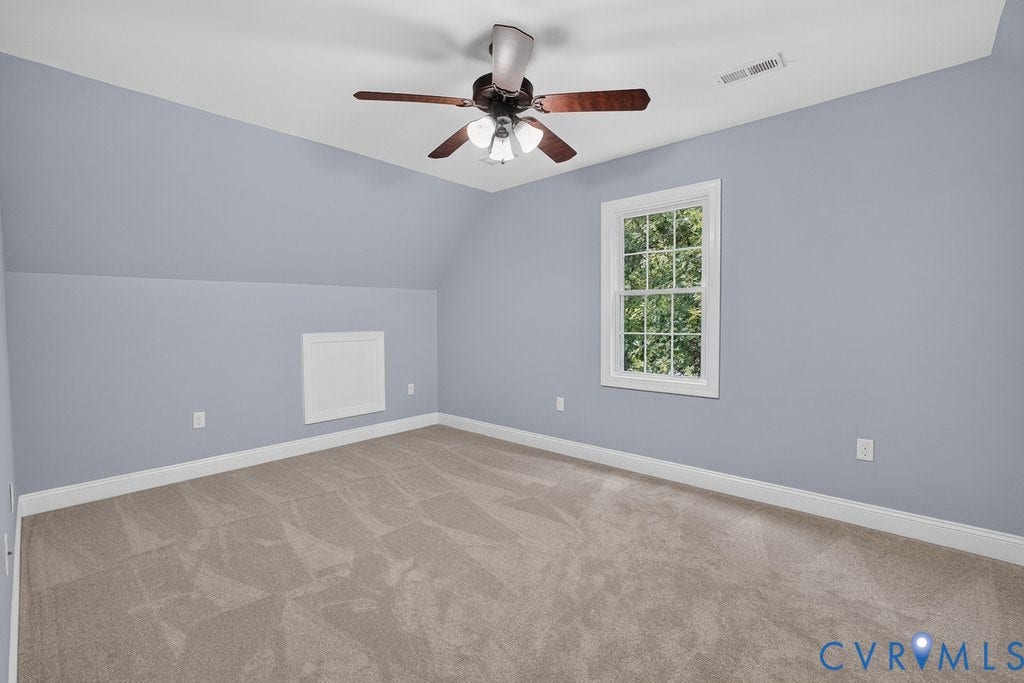 8825 First Branch Lane, Chesterfield, VA 23838 Light gray walls with sloped ceiling details, a white-framed multi-pane window, and a ceiling fan with light fixture