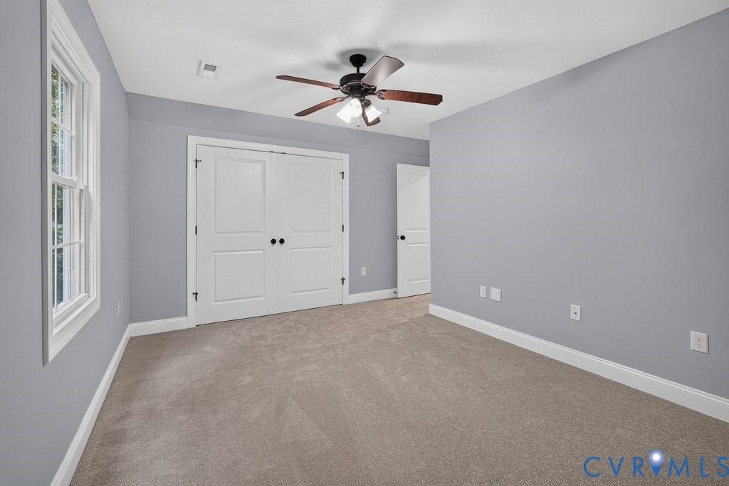 8825 First Branch Lane, Chesterfield, VA 23838 Wall-to-wall carpeting, white trim, double bi-fold doors, white window framing, and an overhead ceiling fan