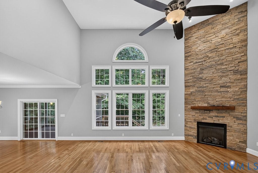 8825 First Branch Lane, Chesterfield, VA 23838 Soaring two-story great room with cathedral ceiling and ceiling fan, anchored by a striking brick fireplace with dark surround