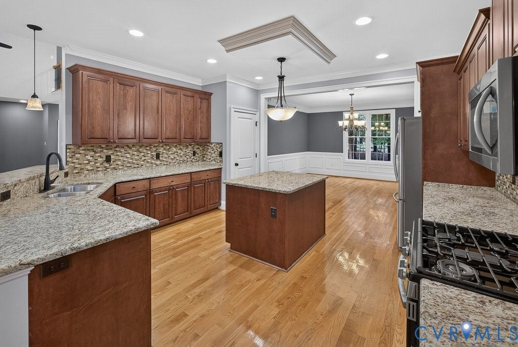 8825 First Branch Lane, Chesterfield, VA 23838 Kitchen featuring granite countertops, wood-finish flooring, wood cabinetry, a built-in microwave, and a gas range