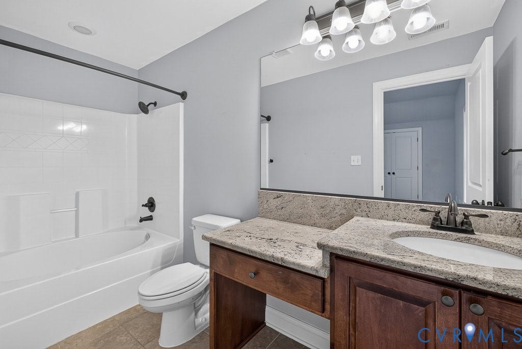 8825 First Branch Lane, Chesterfield, VA 23838 Granite vanity countertop with an integrated sink, dark wood-finish cabinetry, and a full-width mirror