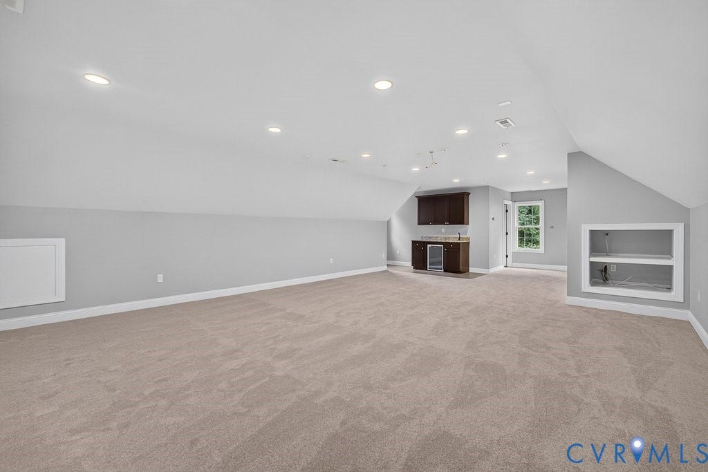 8825 First Branch Lane, Chesterfield, VA 23838 Recessed lighting, sloped ceilings, built-in wet bar with dark wood cabinetry, built-in beverage refrigerator, and built-in shelving