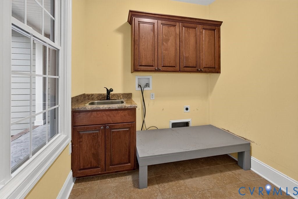 8825 First Branch Lane, Chesterfield, VA 23838 Utility room featuring a window, built-in cabinetry, a sink with a dark faucet, a countertop, and tile flooring