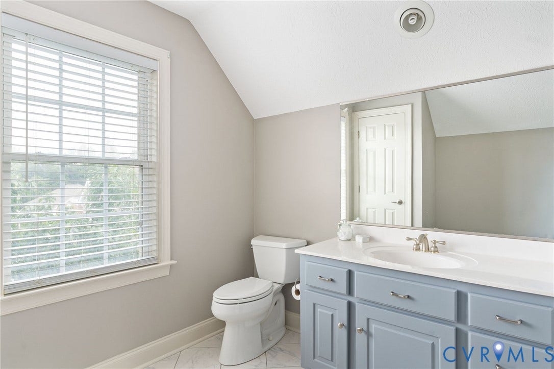 Bathroom vanity featuring a light blue base, a white countertop, and an integrated white sink with a brushed nickel faucet