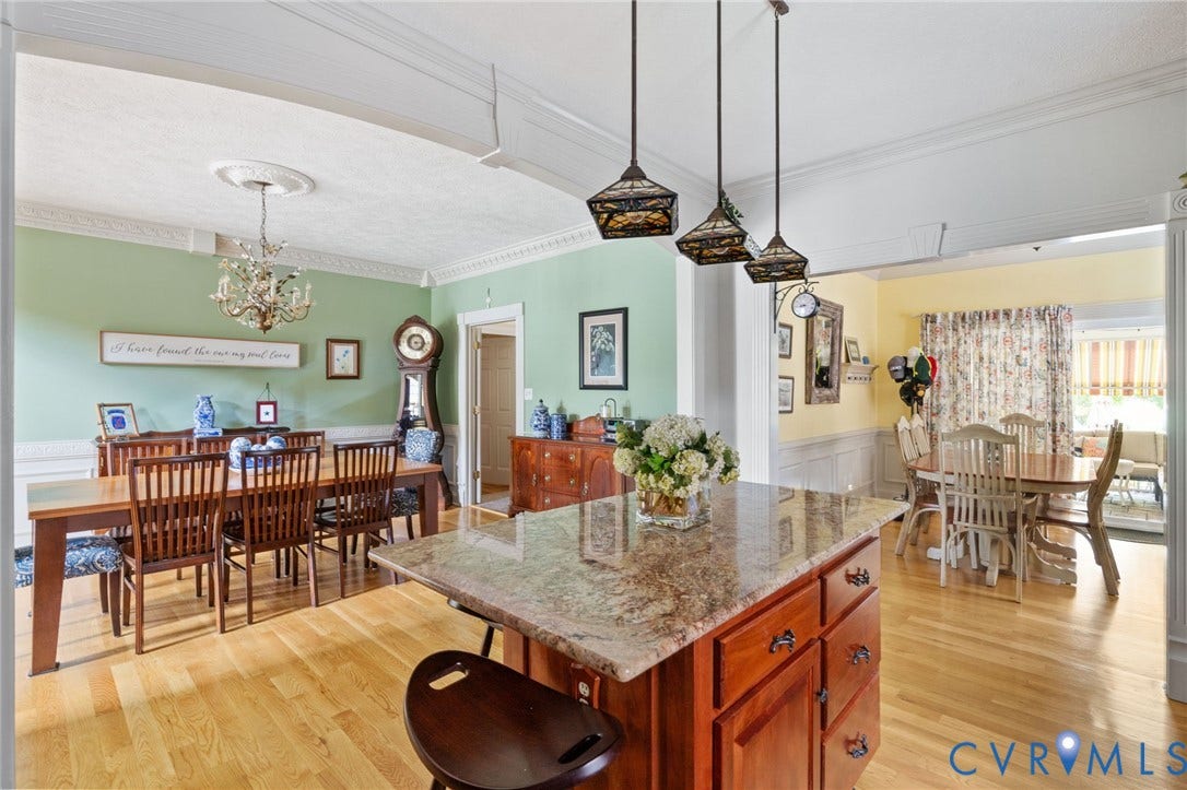 Kitchen island with a granite countertop and dark wood cabinetry