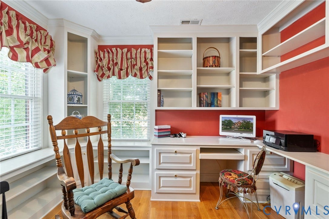 Integrated built-in desk with extensive cabinetry and open shelving