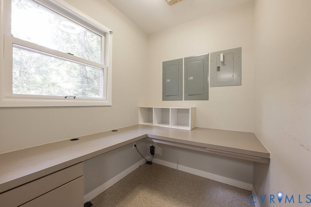 Built-in L-shaped desk with integrated storage and a window