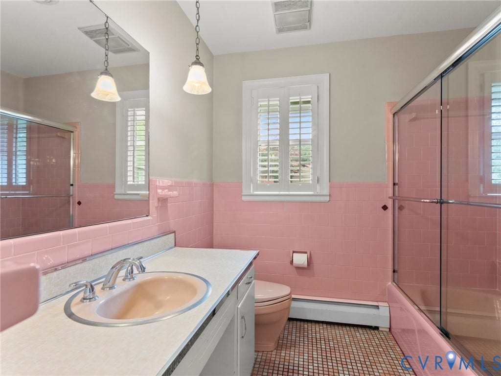 Bathroom featuring a full vanity with an integrated sink, polished chrome faucet, and a large wall-mounted mirror