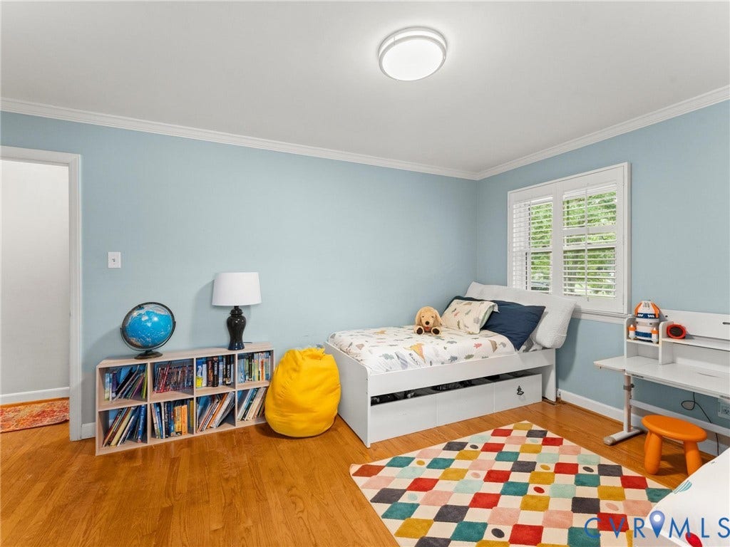 Bright room featuring hardwood flooring and light blue walls