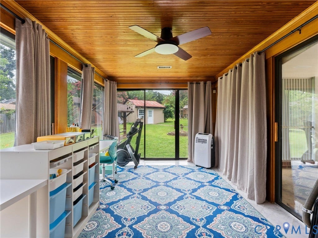 Sunroom with wood-finish ceiling, multiple windows, and a ceiling fan