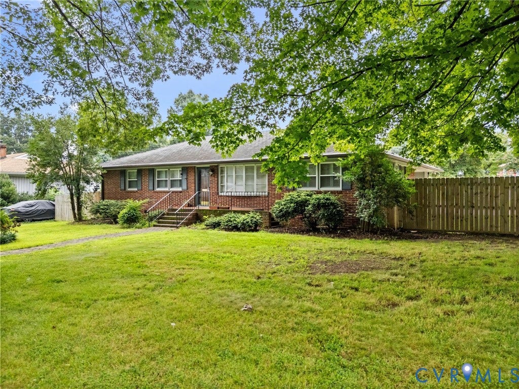 Charming brick ranch home situated on a spacious, level lawn with mature shade trees