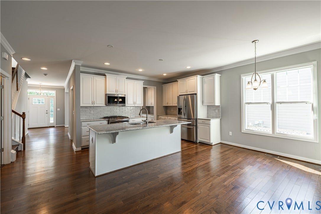 Open-concept living space featuring a kitchen island with granite and separate breakfast nook