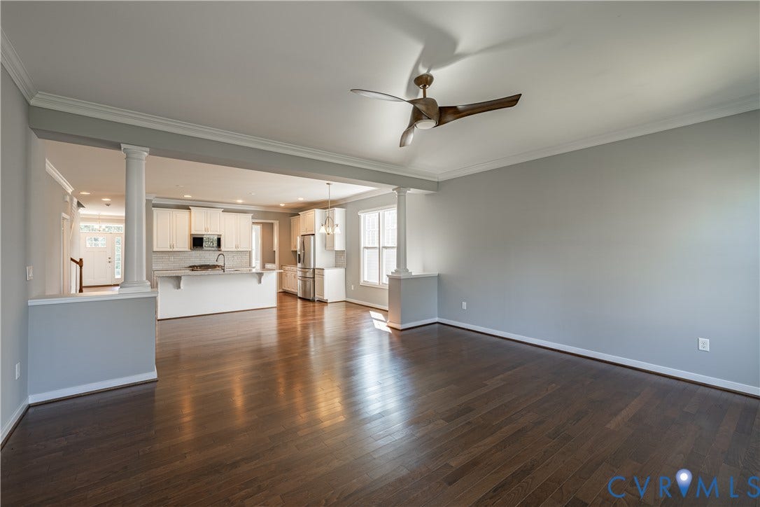 Hardwood flooring throughout, crown molding, modern ceiling fan