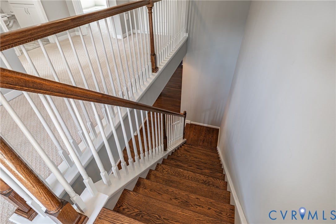 Hardwood stairs with white risers and wood-finish handrails