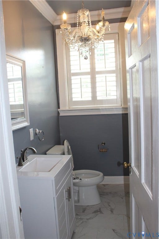 3013 Hawthorne, Richmond, VA 23222 White vanity with an integrated sink, crystal chandelier, plantation shutters, and patterned tile flooring